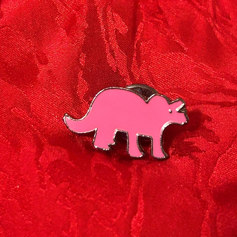Pink triceratops pin